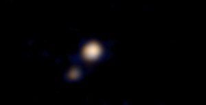 On April 9, this image of Pluto and its largest moon, Charon, was taken by the Ralph color imager aboard NASA’s New Horizons spacecraft and downlinked to Earth the following day. It is the first color image ever made of the Pluto system by a spacecraft on approach. The image is a preliminary reconstruction, which will be refined later by the New Horizons science team. Clearly visible are both Pluto and the Texas-sized Charon. The image was made from a distance of about 71 million miles (115 million kilometers)—roughly the distance from the Sun to Venus. At this distance, neither Pluto nor Charon is well resolved by the color imager, but their distinctly different appearances can be seen. As New Horizons approaches its flyby of Pluto on July 14, it will deliver color images that eventually show surface features as small as a few miles across. Credit: NASA/Johns Hopkins University Applied Physics Laboratory/Southwest Research Institute