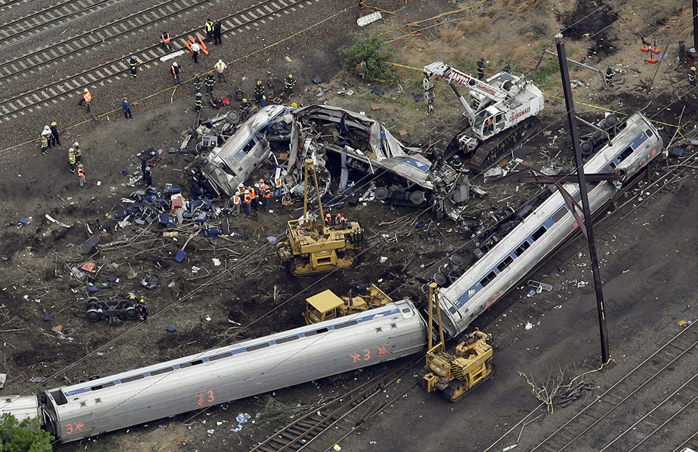 Emergency personnel work at the scene of a deadly train derailment, Wednesday, May 13, 2015, in Philadelphia. The Amtrak train, headed to New York City, derailed and crashed in Philadelphia on Tuesday night, killing at least six people and injuring dozens of others. Credit: AP Photo