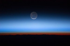 A full moon rises over Earth in a photo take from the International Space Station. Tonight, the second full moon of the month—the blue moon—will appear in the sky. (c NASA)