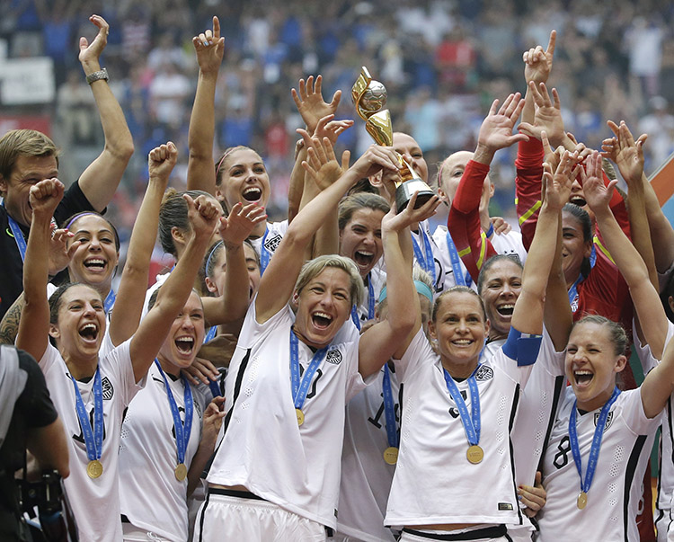 The United States Women's National Team celebrates with the trophy after they beat Japan 5-2 in the FIFA Women's World Cup soccer championship in Vancouver, British Columbia, Canada, Sunday, July 5, 2015. Credit: © Elaine Thompson, AP Photo