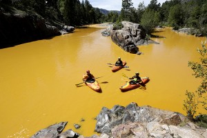 People kayak in the Animas River near Durango, Colo., Thursday, Aug. 6, 2015, in water colored from a mine waste spill. The U.S. Environmental Protection Agency said that a cleanup team was working with heavy equipment Wednesday to secure an entrance to the Gold King Mine. Workers instead released an estimated 1 million gallons of mine waste into Cement Creek, which flows into the Animas River. Credit: © Jerry McBride, The Durango Herald/AP Images