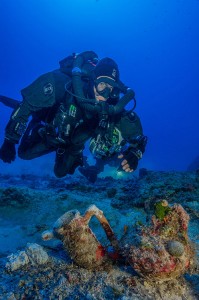 Archaeologists excavating the famous ancient Greek shipwreck that yielded the Antikythera Mechanism have recovered more than 50 items, including an intact amphora; a large lead salvage ring, two lead anchor stocks (possibly indicating the ship’s bow), fragments of lead hull sheathing, and a small and finely formed lagynos (or table jug). (Credit: Brett Seymour, EUA/ARGO/Woods Hole Oceanographic Institute)