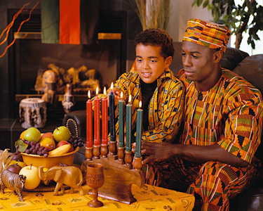 Kwanzaa is an African American holiday that begins on December 26 and lasts for seven days. The holiday centers on seven principles. Each evening, families exchange gifts, light one of the seven candles, and discuss the day's principle. This child is shown lighting one of the seven candles. Credit: © Corbis