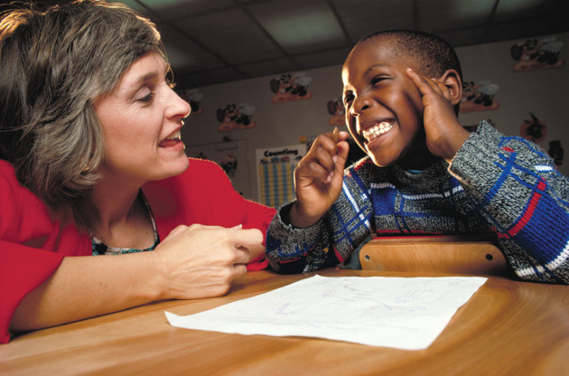 A teacher and student work together in a special education classroom. Special education is designed to help both disabled and gifted children use their full learning ability.  Credit: © Richard T. Nowitz, Photo Researchers