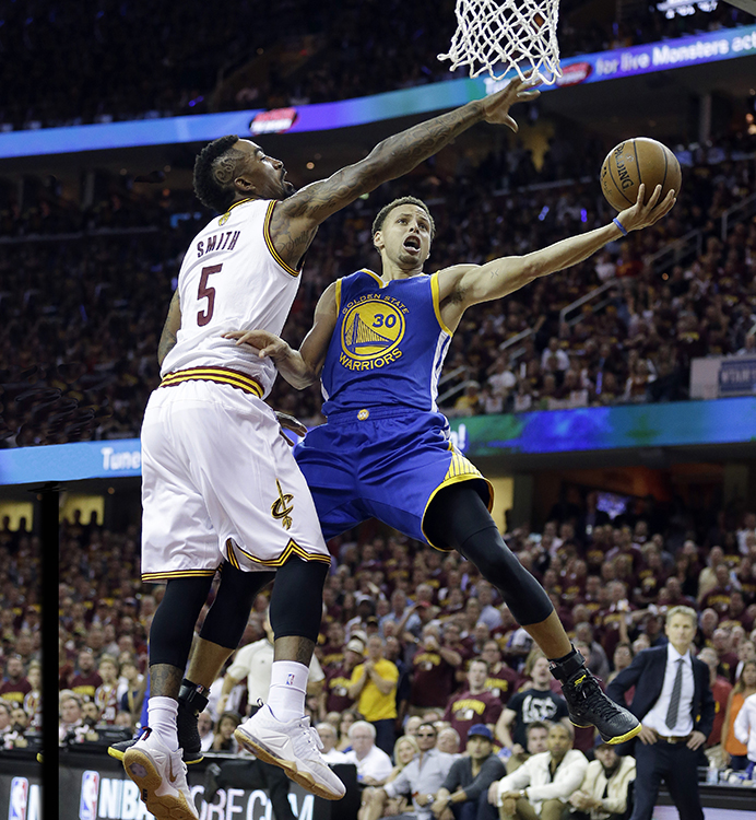 Golden State Warriors guard Stephen Curry (30) puts up a shot against Cleveland Cavaliers guard J.R. Smith (5). Credit: © Tony Dejak, AP Photo