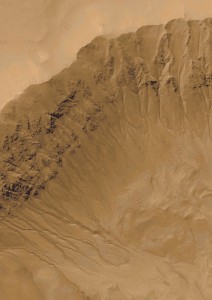 Deep channels descending a crater wall on Mars showing evidence of water. Credit: NASA