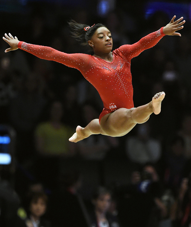 Simone Biles of the United States performs the floor exercise portion of the women's all-around final at the world gymnastics championships in Glasgow, Scotland, on Oct. 29, 2015. Biles became the first woman to win three consecutive world all-around titles. Credit: © Kyodo/AP Photo