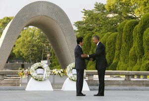 U.S. President Barack Obama, right, and Japanese Prime Minister Shinzo Abe shake hands after laying wreaths at Hiroshima Peace Memorial Park in Hiroshima, western, Japan, Friday, May 27, 2016. Obama on Friday became the first sitting U.S. president to visit the site of the world's first atomic bomb attack, bringing global attention both to survivors and to his unfulfilled vision of a world without nuclear weapons. Credit: © Kimimasa Mayama, Pool Photo/AP Photo