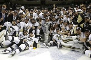 Pittsburgh Penguins players, coaches, and staff pose with the Stanley Cup trophy after defeating the San Jose Sharks in game six of the National Hockey League's Stanley Cup Final on June 12, 2016.  Credit: © Marcio Jose Sanchez, AP Photo