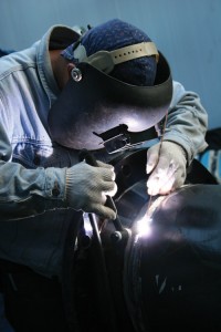 In helium arc welding, sometimes called heliarc welding, helium is blown over the area being welded to protect the metal from reacting with oxygen in the air. This photograph shows a worker heliarc welding. Credit: © Thinkstock