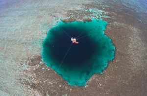 Aerial view of the experts and staff exploring the Sansha Yongle Blue Hole on July 24, 2016 in Xisha Islands, Sansha City, Hainan Province of China. Sansha municipal government has named the world's deepest ocean blue hole as "Sansha Yongle Blue Hole" which is located around the Yongle atoll of the Xisha Islands. The hole has a vertical depth of 300.89 meters, a diameter of 130 meters on the surface, and its bottom's diameter is 36 meters. No connection between the hole and the outside sea has been found so far and the water inside the hole has no obvious flow. Credit: © Luo Yunfei, VCG/Getty Images