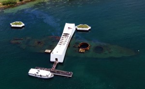 An aerial view of the USS Arizona Memorial with a US Navy Tour Boat, USS Arizona Memorial Detachment, moored at the pier as visitor disembark to visit and pay their respects to the sailors and Marines who lost their lives during the attack on Pearl Harbor on Dec. 7, 1941. Credit: National Park Service