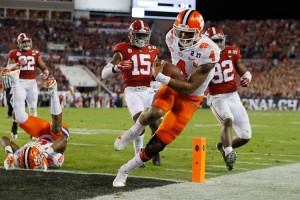 Quarterback Deshaun Watson #4 of the Clemson Tigers rushes for an 8-yard touchdown during the second quarter against the Alabama Crimson Tide in the 2017 College Football Playoff National Championship Game at Raymond James Stadium on January 9, 2017 in Tampa, Florida. Credit: © Kevin C. Cox, Getty Images