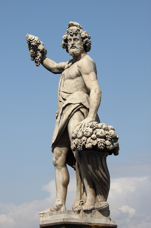 This statue of Dionysus, the god of wine, holds a bunch of grapes. The statue stands at Holy Trinity Bridge in Florence, Italy. Credit: © Shutterstock