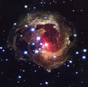 A red supergiant called V838 Monocerotis glows at the center of a dust cloud in this photograph taken by the Hubble Space Telescope. In 2002, the star gave off a brilliant flash of light, becoming 600,000 times as bright as the sun. The flash illuminated dust thrown off the star during a previous outburst. Credit: NASA/ESA/H.E. Bond (STScI)
