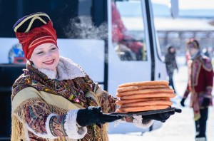 Woman offers pancakes on Maslenitsa Russian folk holiday. Traditional pancakes are served at several different Carnival celebrations around the world. Here, a Russian woman offers fluffy crêpes on Maslenitsa, the day before Ash Wednesday. Credit: © Shutterstock