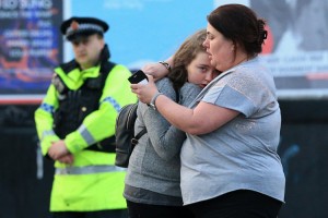 Walking casualties Vikki Baker and her thirteen year old daughter Charlotte hug outside the Manchester Arena stadium in Manchester, United Kingdom on May 23, 2017. A large explosion was reported at the end of a concert by American singer Ariana Grande. So far, police have confirmed 20 dead and over fifty injured in the explosion, now thought to be terrorist-related. Credit: © Lindsey Parnaby, Anadolu Agency/Getty Images