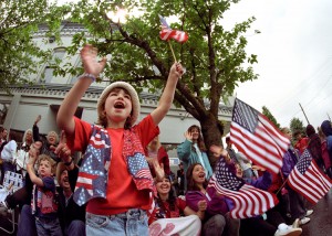 An Independence Day celebration in the United States draws a flag-waving crowd, seen in this photograph, to watch a patriotic parade. Independence Day, also called the Fourth of July, commemorates the 1776 Declaration of Independence from British rule. Celebrations commonly include picnics, concerts, and large public displays of fireworks. Credit: © D. Hurst, Alamy Images
