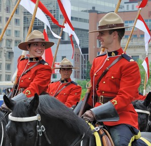 The Royal Canadian Mounted Police (RCMP) is the federal police force of Canada. These RCMP officers ride their horses in a parade on Canada Day. Credit: © William MacKenzie, Getty Images