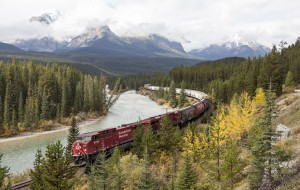 Freight train moving along Bow river in Canadian Rockies on September 18, 2015 in, Banff national Park, Alberta, Canada. Credit: © Shutterstock
