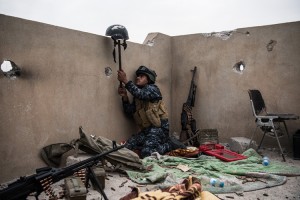 An Iraqi federal policeman uses a helmet on a stick to try and draw fire from an Islamic State sniper in an attempt to make him reveal his position during the battle to recapture west Mosul on April 13, 2017 in Mosul, Iraq. Despite being completely surrounded, Islamic State fighters are continuing to put up stiff resistance to Iraqi forces who are now having to engage I.S in house to house fighting as they continue their battle to retake Iraq's second largest city of Mosul. Credit: © Carl Court, Getty Images