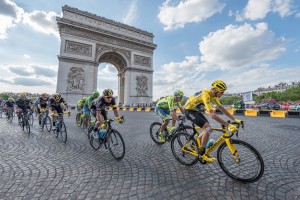 The road racing cyclist Christopher Froome, wearing the leader's yellow jersey in front of Arc de Triomphe during the Tour de France 2016 on the Champs Elysees Avenue. Credit: © Frederic Legrand, COMEO/Shutterstock