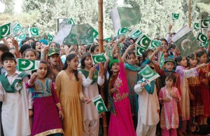 Children hold national flags and sing National Songs during ceremony held at provincial assembly building on occasion of the Independence Day on August 14, 2011in Quetta, Pakistan. Credit: © Asianet-Pakistan/Shutterstock