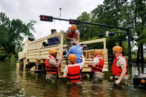 Texas National Guardsmen assist residents affected by flooding caused by Hurricane Harvey onto a military vehicle in Houston, Aug. 27, 2017. Credit: Lt. Zachary West, Army National Guard 