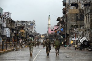 Philippine soldiers walk past destroyed buldings in Bangolo district, after President Rodrigo Duterte declared Marawi City 'liberated', in Marawi on October 17, 2017. Philippine President Rodrigo Duterte on October 17 symbolically declared a southern city 'liberated from terrorists' influence' but the military said the five-month battle against militants loyal to the Islamic State group was not yet over. Credit: © Ted Aljibe, AFP/Getty Images