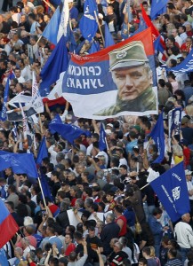 Supporters of Ratko Mladić wave flags and a banner with his likeness during a rally in Belgrade, Serbia, where many consider him a hero. Mladić was sentenced to life in prison for genocide and other war crimes on Nov. 22, 2017. Supporters of genocide suspect Ratko Mladic wave flags with him picture and reading in Serbian: "Serbian Hero" during a rally organized by the ultra nationalist Serbian Radical Party in front of the Parliament building, in Belgrade, Serbia, on Sunday, May 29, 2011. Thousands of demonstrators sang nationalist songs and carried banners honoring jailed former Bosnian Serb army commander Ratko Mladić on Sunday as they poured into the street outside Serbia's parliament to demand the release of the war-crimes suspect, whom they consider a hero. Credit: © Darko Vojinovic, AP Photo