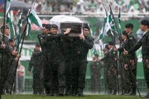 On Dec. 3, 2016, Brazilian air force members carry the coffin of a Chapecoense player during a memorial service for the team’s players, coaches, and staff killed in the crash of Flight 2933. Brazilian President Michel Temer was among the more than 20,000 mourners at the rain-soaked service at Chapecó’s Arena Condá.  Air Force troops carry coffin of one of the victims of the plane crash in Colombia at the Arena Conda stadium on December 03, 2016 in Chapecó, Brazil. Players of the Chapecoense soccer team were among the 77 people on board the doomed flight that crashed into mountains in northwestern Colombia. Officials said just six people were thought to have survived, including three of the players. Chapecoense had risen from obscurity to make it to the Copa Sudamericana finals against Atletico Nacional of Colombia. Credit: © Buda Mendes, Getty Images