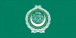 The official flag of the Arab League is green with the emblem of the league in the center. The emblem features Arabic letters surrounded by a crescent, a yellow chain, and a white wreath. Credit: Flag Research Center
