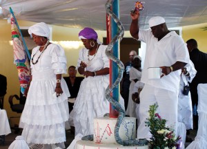 Followers of Vodou, called Vodouisants, participate in a memorial ceremony in Haiti. They wear white clothing to symbolize mourning. Africans brought Vodou beliefs to Haiti in the 1700’s. Credit: © Kena Betancur, Reuters/Landov