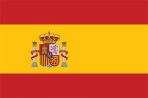 The flag of Spain has two horizontal red stripes with a wider yellow stripe between them. Spain’s state flag , flown by the government, includes the national coat of arms on the yellow stripe. The coat of arms features a shield, a crown, and two white pillars. The shield contains symbols representing historic regions of Spain and the Spanish royal family. The civil flag , flown by individual citizens, has plain stripes without the coat of arms. Credit: © Loveshop/Shutterstock