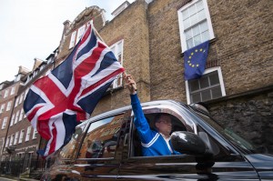 A London taxi driver waves a Union Jack flag in Westminster, London after Britain voted to leave the European Union in an historic referendum which has thrown Westminster politics into disarray and sent the pound tumbling on the world markets.  Credit: © Stefan Rousseau, PA Wire/AP Photo
