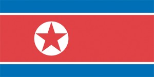 North Korea's flag has a horizontal red stripe between two thin white stripes on a blue background. The flag of North Korea have a red star that represents Communism. © Julia Sanders, Shutterstock