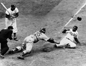 Jackie Robinson, shown here sliding into home plate, became the first African American player in modern major league baseball. He joined the Brooklyn Dodgers in 1947. Robinson gained fame for his hitting and his daring base running. Credit: UPI/Corbis-Bettmann 