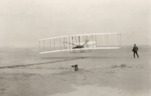 The American brothers Wilbur and Orville Wright built the first successful airplane. In this photograph, Wilbur looks on as Orville pilots their plane, called the Flyer, near Kitty Hawk, North Carolina, marking the world's first flight in a heavier-than-air vehicle. Credit: © Classic Image/Alamy Images 