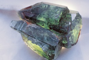 An emerald is a rich green gemstone that is a variety of the mineral beryl. An emerald with a blue tint, such as the uncut one shown here, is more valuable than one with a yellow tint. Credit: © Carl Frank, Photo Researchers 