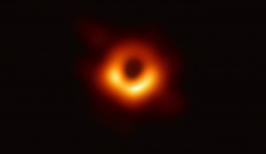 The Event Horizon Telescope (EHT) — a planet-scale array of eight ground-based radio telescopes forged through international collaboration — was designed to capture images of a black hole. In coordinated press conferences across the globe, EHT researchers revealed that they succeeded, unveiling the first direct visual evidence of the supermassive black hole in the centre of Messier 87 and its shadow. The shadow of a black hole seen here is the closest we can come to an image of the black hole itself, a completely dark object from which light cannot escape. The black hole’s boundary — the event horizon from which the EHT takes its name — is around 2.5 times smaller than the shadow it casts and measures just under 40 billion km across. While this may sound large, this ring is only about 40 microarcseconds across — equivalent to measuring the length of a credit card on the surface of the Moon. Although the telescopes making up the EHT are not physically connected, they are able to synchronize their recorded data with atomic clocks — hydrogen masers — which precisely time their observations. These observations were collected at a wavelength of 1.3 mm during a 2017 global campaign. Each telescope of the EHT produced enormous amounts of data – roughly 350 terabytes per day – which was stored on high-performance helium-filled hard drives. These data were flown to highly specialised supercomputers — known as correlators — at the Max Planck Institute for Radio Astronomy and MIT Haystack Observatory to be combined. They were then painstakingly converted into an image using novel computational tools developed by the collaboration. Credit: EHT Collaboration/ESO