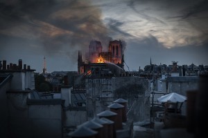 Flames and smoke are seen billowing from the roof at Notre-Dame Cathedral on April 15, 2019 in Paris, France. A fire broke out on Monday afternoon and quickly spread across the building, collapsing the spire. The cause is yet unknown but officials said it was possibly linked to ongoing renovation work.  Credit: © Veronique de Viguerie, Getty Images
