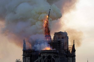 The steeple and spire of the landmark Notre-Dame Cathedral collapses as the cathedral is engulfed in flames in central Paris on April 15, 2019.  Credit: © Geoffroy Van Der Hasselt, AFP/Getty Images
