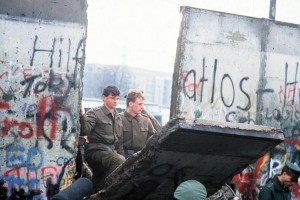 East German police step into West Berlin as a block of the Berlin Wall falls in November 1989. East and West Germany reunited as one nation in 1990. Credit: AP Photo 
