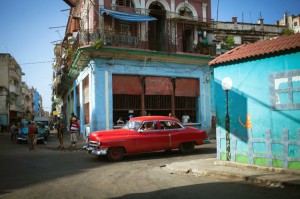 A street scene in Havana, Cuba's capital, features colorful buildings and old-fashioned cars. Because of a trade embargo, Cubans could not buy newer cars for many years. Credit: © Shutterstock 