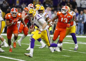 LSU Tigers quarterback Joe Burrow (9) rushes in for a touchdown during the first half of the College Football Playoff National Championship Game between the LSU Tigers and the Clemson Tigers on January 13, 2020 in New Orleans LA.  Credit: © Todd Kirkland, Icon Sportswire/Getty Images