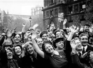 A cheering crowd in London, England, welcomes the end of fighting in Europe during World War II on May 8, 1945—a day remembered as Victory in Europe (V-E) Day. Photo credit: © Popperfoto/Getty Images