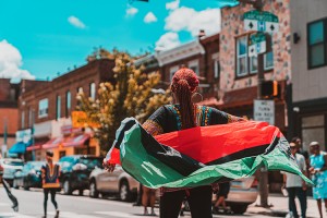 A woman carries the Pan-African flag, a symbol of black unity, at a Juneteenth parade in Philadelphia, Pennsylvania. Juneteenth celebrations commemorate the freeing of slaves in Galveston, Texas, on June 19, 1865. Credit: © Tippman98x/Shutterstock
