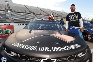 The American automobile racing driver Bubba Wallace poses next to his car, number 43, before a race at Martinsville Speedway in Virginia in 2020. Wallace, who is African American, sported a Black Lives Matter theme on his car in the wake of the George Floyd killing. Credit: © Jared C. Tilton, Getty Images