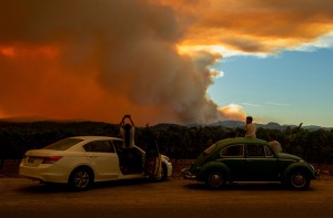 Motorists stop to observe the Walbridge fire, part of the larger LNU Lightning Complex fire, from a vineyard in Healdsburg, California, on Aug. 20, 2020. A series of massive fires in northern and central California forced evacuations as flames quickly spread, darkening the skies and polluting the air.  Credit: © Josh Edelson, AFP/Getty Images