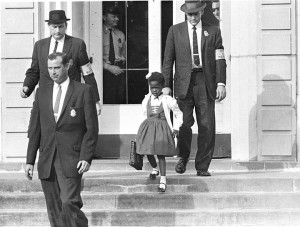 Six-year-old Ruby Bridges is escorted by United States deputy marshals at William Frantz Elementary School in New Orleans, Louisiana, in November 1960. The first-grader was the only Black child enrolled in the school, where parents of white students boycotted the court-ordered integration law. Credit: AP/Wide World 